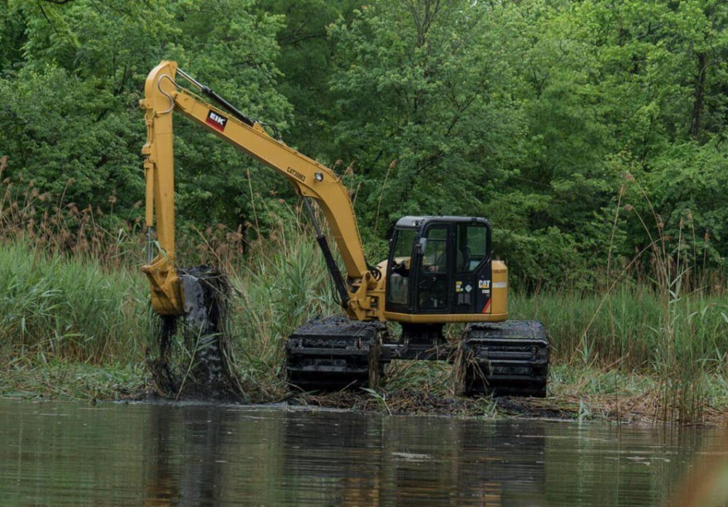 Amphibious excavators combine hydraulic power with floating stability, making them essential for marine construction and flood control projects. Their spud-compatible design ensures precision and balance during pile driving, dredging, and deep-water excavation. Photo Credit: EIK Solutions