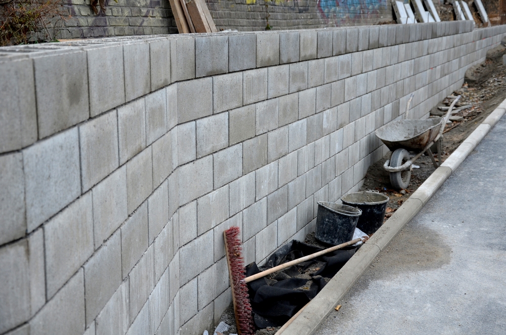 Soil stabilization along retaining walls often uses low‑mobility grouts or compaction grouting injected through ports at depth. The grout bulks up the soil matrix, reducing settlement and preventing groundwater ingress around deep foundations.