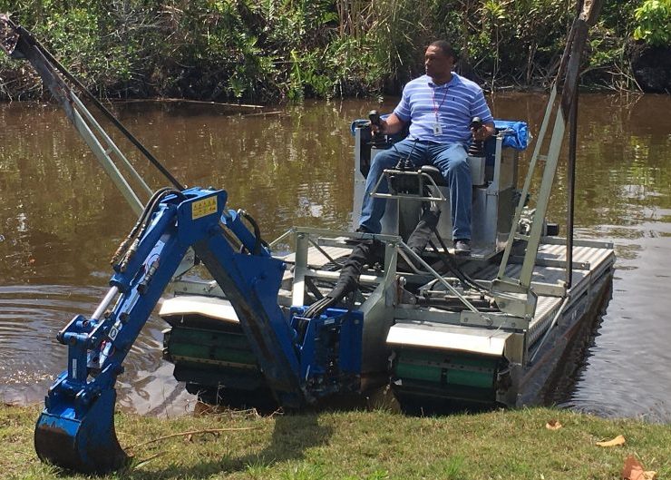 Amphibious construction machines are designed with low ground pressure systems that allow them to operate on saturated soils without sinking. This makes them suitable for waterfront piling projects where conventional equipment cannot maintain stability. Photo Credit: Mobitrac-USA