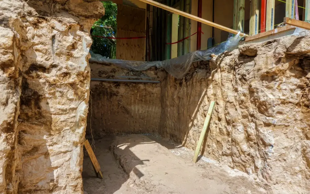 Permeation grouting strengthens soil by filling existing pore spaces with low-viscosity grout without disturbing the soil structure. This makes it ideal for stabilizing sands and gravels beneath deep foundations and existing structures. Photo Credit: TerraGrout