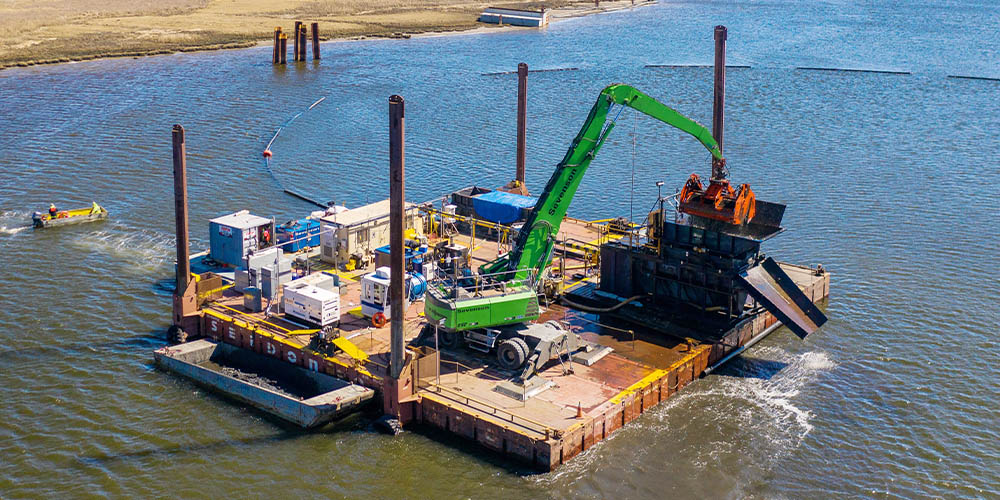 Hydraulic dredging moves sediment as a slurry through pipelines, making it effective for large volumes of fine-grained material in open waterways. It is widely used for navigation channel maintenance and beach nourishment projects. Photo Credit: Sevenson Environmental Services