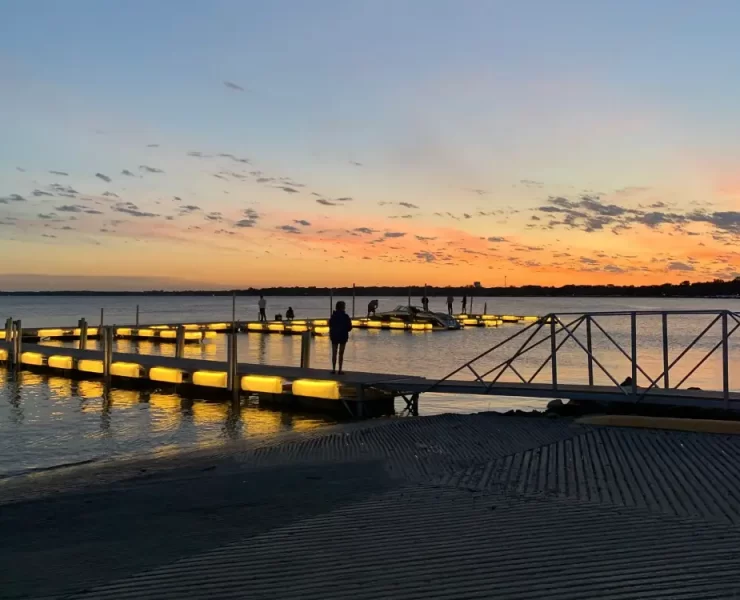 Floating docks rely on piles or anchors primarily for lateral stability rather than vertical load support. This allows the dock system to rise and fall with changing water levels without overstressing the foundation. Photo Credit: Pier Genius