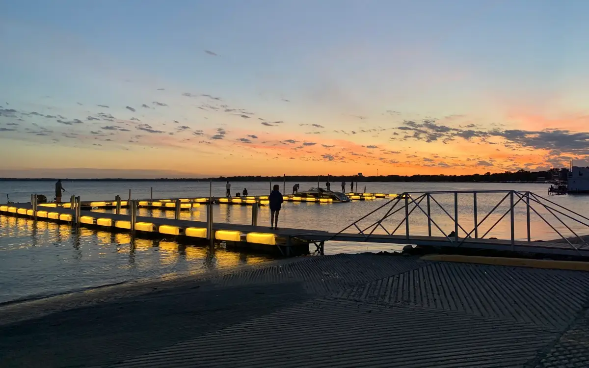 Floating docks rely on piles or anchors primarily for lateral stability rather than vertical load support. This allows the dock system to rise and fall with changing water levels without overstressing the foundation. Photo Credit: Pier Genius