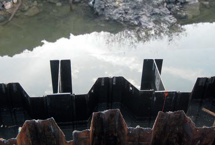 Hybrid H-pile and sheet pile walls use structural king piles to carry most bending forces while intermediary sheet piles transfer earth and water pressures. This load sharing significantly increases wall stiffness compared to conventional sheet pile systems. Photo Credit: Steelwall ISH GmbH