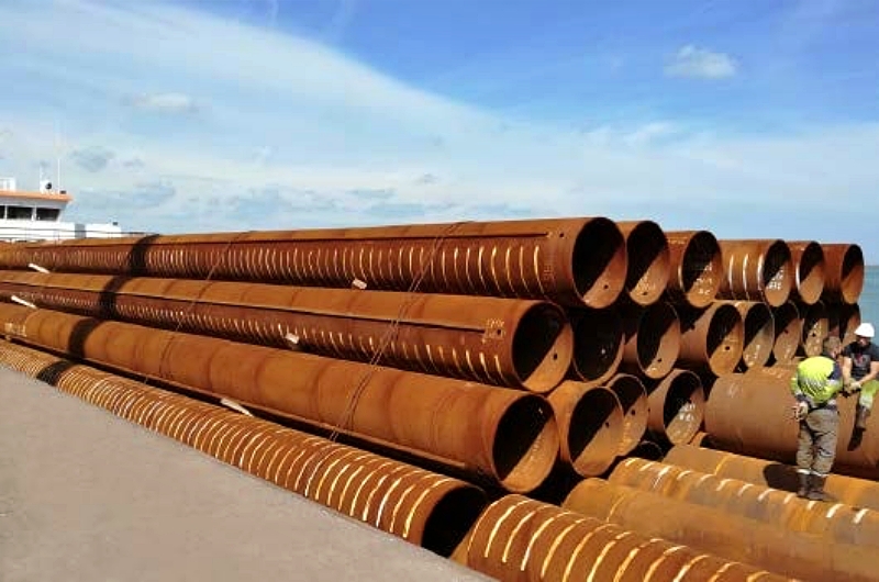 Large-diameter steel pipe piles are commonly used in marine and heavy civil construction because they can transfer high axial and lateral loads to deeper, more stable soil layers. Their circular shape provides efficient structural performance in both soft and variable ground conditions. Photo Credit: NOKSEL ESPAÑA