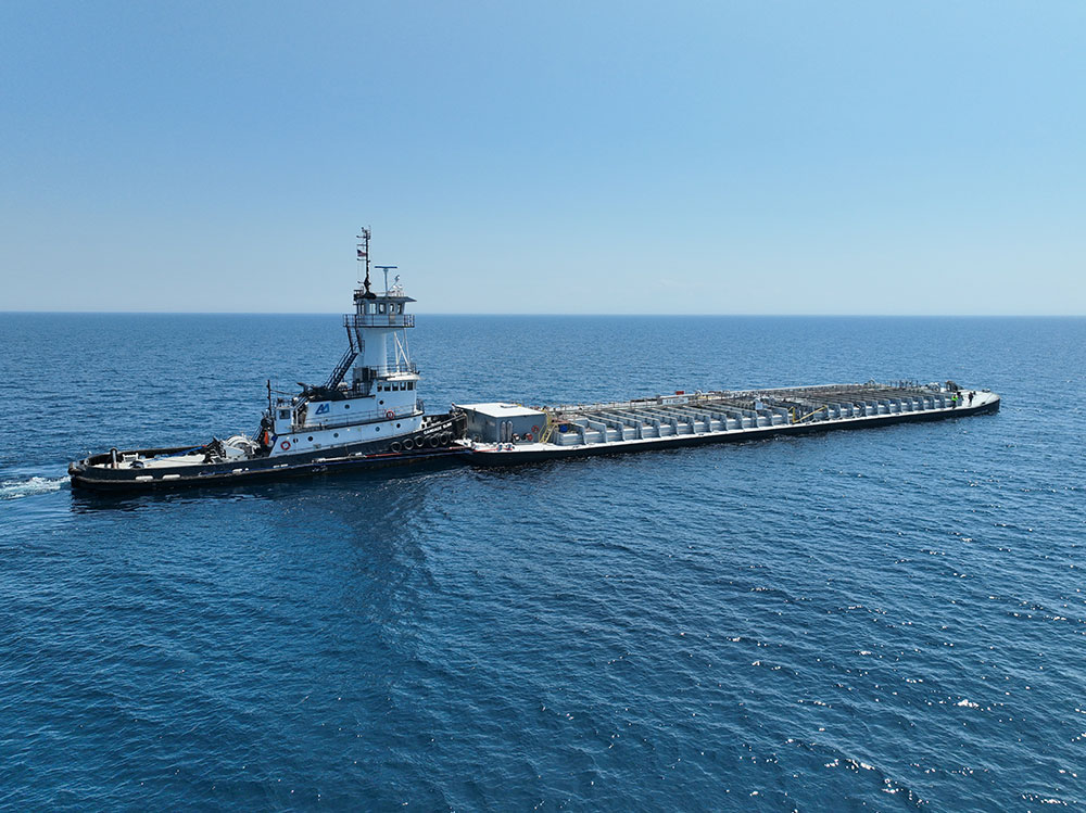 Tugboats enable the movement of oversized and heavy foundation materials that exceed road and rail transport limits. This makes marine transport essential for coastal projects involving piles, precast concrete, and structural steel. Photo Credit: Ashton Marine