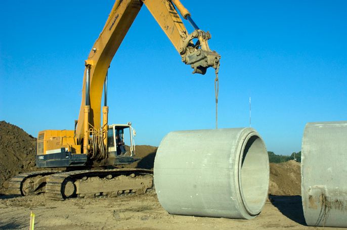 Uncontrolled stormwater runoff is a common cause of scour around pile foundations, especially at discharge points and deck penetrations. Even small, concentrated flows can undermine pile embedment and reduce load capacity if left unmanaged. Photo Credit: Scituate Concrete Products