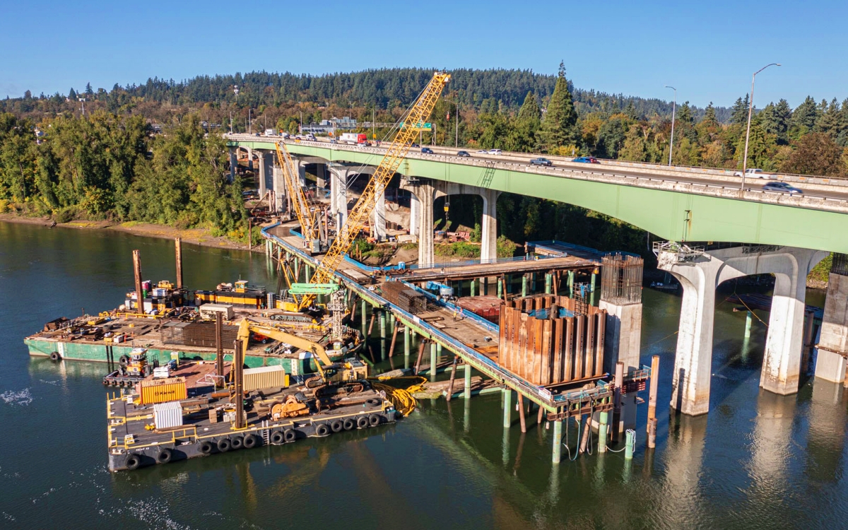 Pile refusal in marine environments is commonly caused by dense sand lenses, glacial deposits, or buried obstructions. Continuing to increase driving energy without adjustment can overstress piles and compromise long-term foundation performance. Photo Credit: Kiewit Corporation