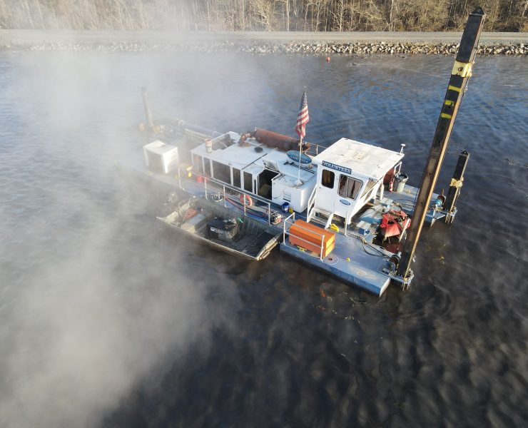 Hydraulic dredging systems transport sediment through pipelines extending thousands of feet from the dredge location without requiring hopper barges. These portable systems excel in confined spaces like inland waterways and industrial basins where traditional large-scale equipment cannot access. Photo Credit: Dredge America, Inc.