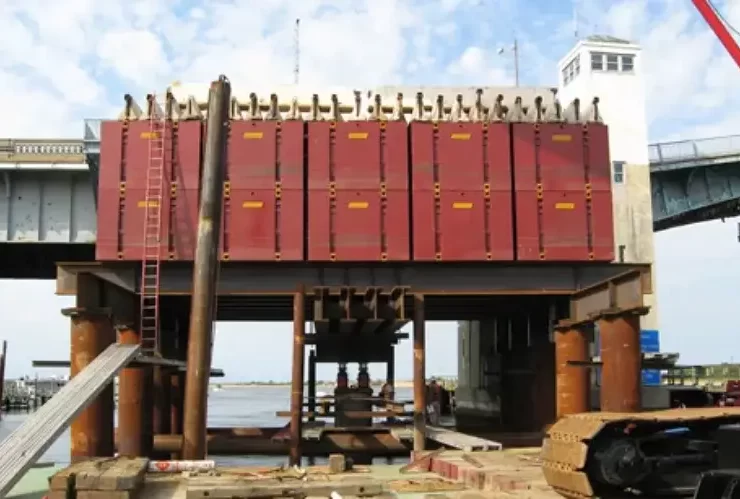 Reaction systems provide the resisting force required to apply load during static pile load testing. Any movement or instability in the reaction system can directly affect test accuracy. Photo Credit: WB Equipment