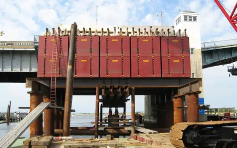 Reaction systems provide the resisting force required to apply load during static pile load testing. Any movement or instability in the reaction system can directly affect test accuracy. Photo Credit: WB Equipment