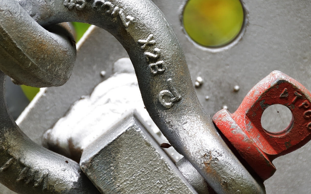 Load rotation often occurs when the center of gravity does not align with the lifting connection, causing torsional forces to develop once the load is airborne. These forces are amplified in marine environments due to wind, vessel movement, and limited tag line control. Photo Credit: Bishop Lifting