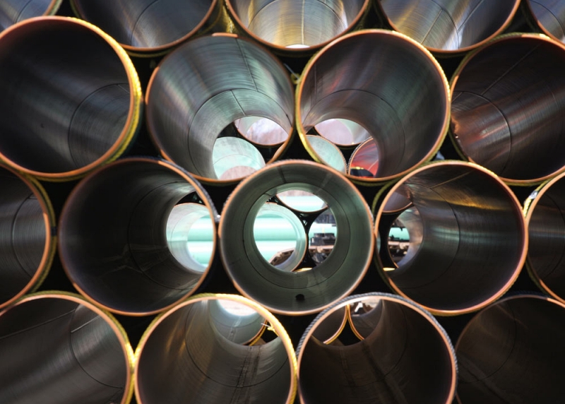 Steel piles provide high load capacity with relatively small cross sections, allowing deeper penetration into dense soils. Their ability to be spliced and driven efficiently makes them ideal for projects with variable subsurface conditions. Photo Credit: Pipe and Piling Supplies Ltd.