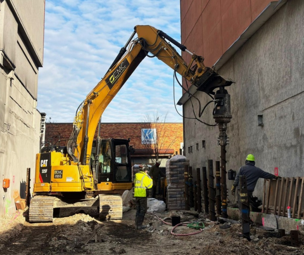 STELCOR® piles are installed within a narrow space between existing buildings at a project site in Brooklyn, New York. Photo Credit: IDEAL Group
